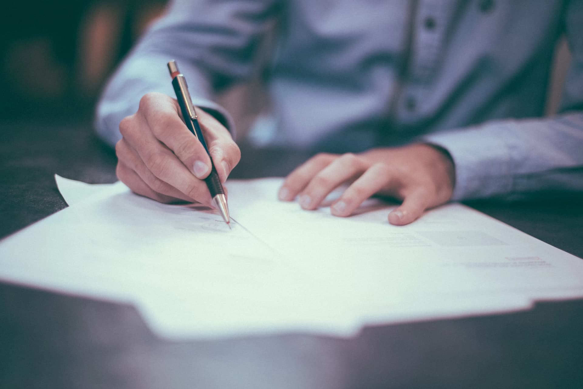 Person filling out a credit check form ready for their new property